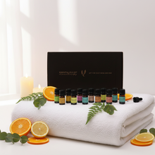 Load image into Gallery viewer, The aromatherapy pure essential oil gift set refresh and revive display out of the box on a folded white towel surrounded by sliced citrus fruits.
