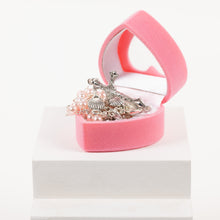 Load image into Gallery viewer, A pink heart-shaped rosary box lays open displaying pink rosary beads inside.