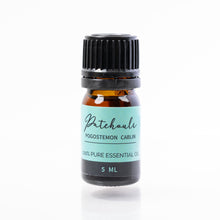 Load image into Gallery viewer, Bottle of Patchouli essential oil with a black cap on a white background