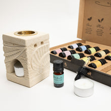 Load image into Gallery viewer, Aromatherapy set with stone diffuser, essential oils, and a candle on a white background
