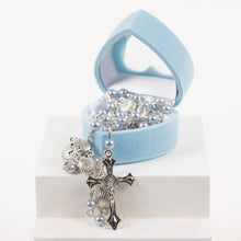Load image into Gallery viewer, A blue heart shaped box with a blue rosary and silver cross.
