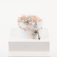 Load image into Gallery viewer, Pink rosary beads with a silver cross and clam shell details.
