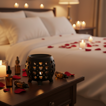 Load image into Gallery viewer, A matte black ceramic oil burner with heart-shaped cut-outs.
