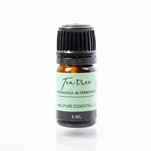 Load image into Gallery viewer, Tea tree essential oil bottle on a white background
